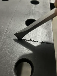 Chisel cleaning heavy buildup of grit