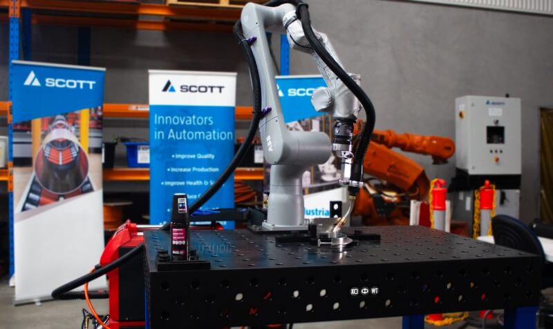 Robotic welder in position on a welding table